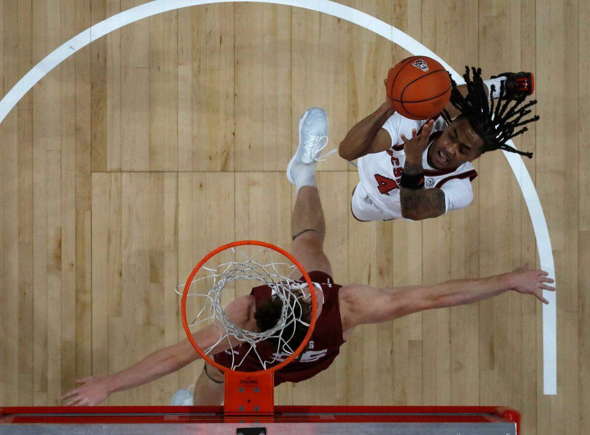 N.C. State’s Breon Pass drives to the basket against Colgate’s Parker Jones during the first half of the Wolfpack’s 72-49 win at Lenovo Center on Monday, Nov. 18, 2024, in Raleigh, N.C.