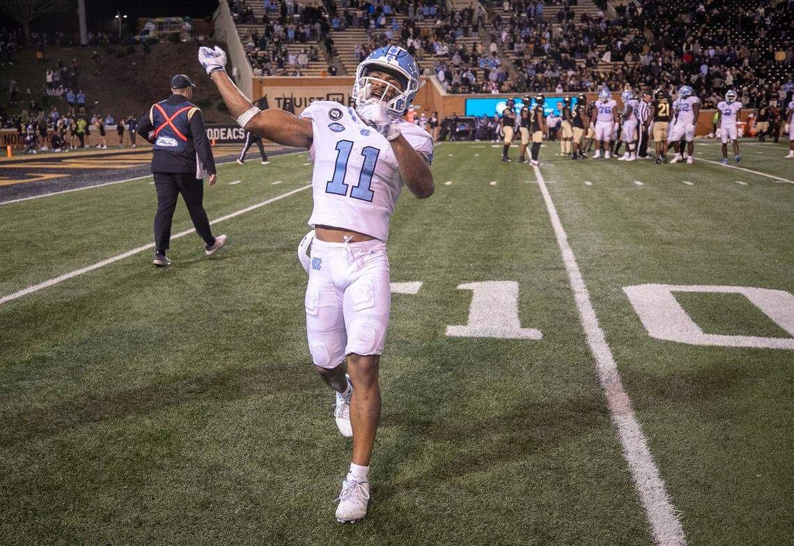 North Carolina’s Josh Downs (11) motions to Tar Heels’ fan section after securing a final first down and a 36-43 victory over Wake Forest on Saturday, November 12, 2022 at Truist Field in Winston-Salem, N.C.