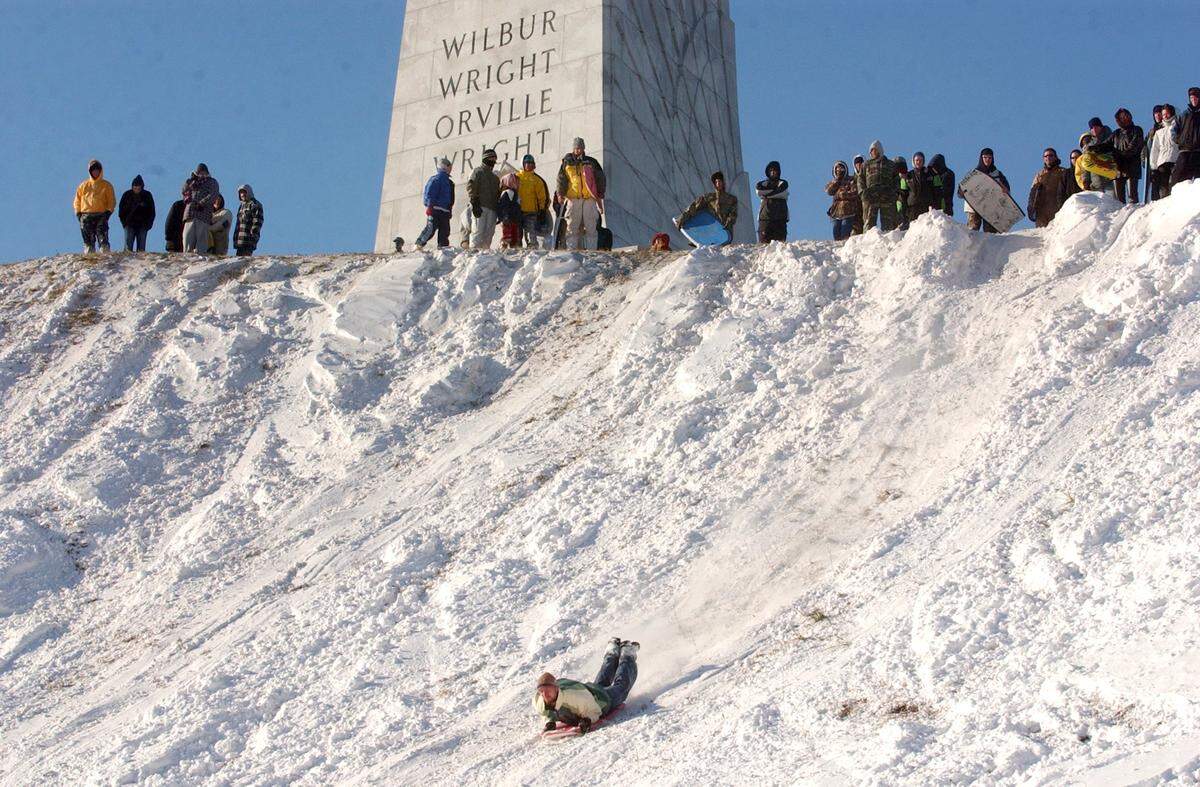 Outer Banks locals gathered at the Wright Brothers Memorial to sled or ski the steep banks after a winter storm hit the area in January 2002.