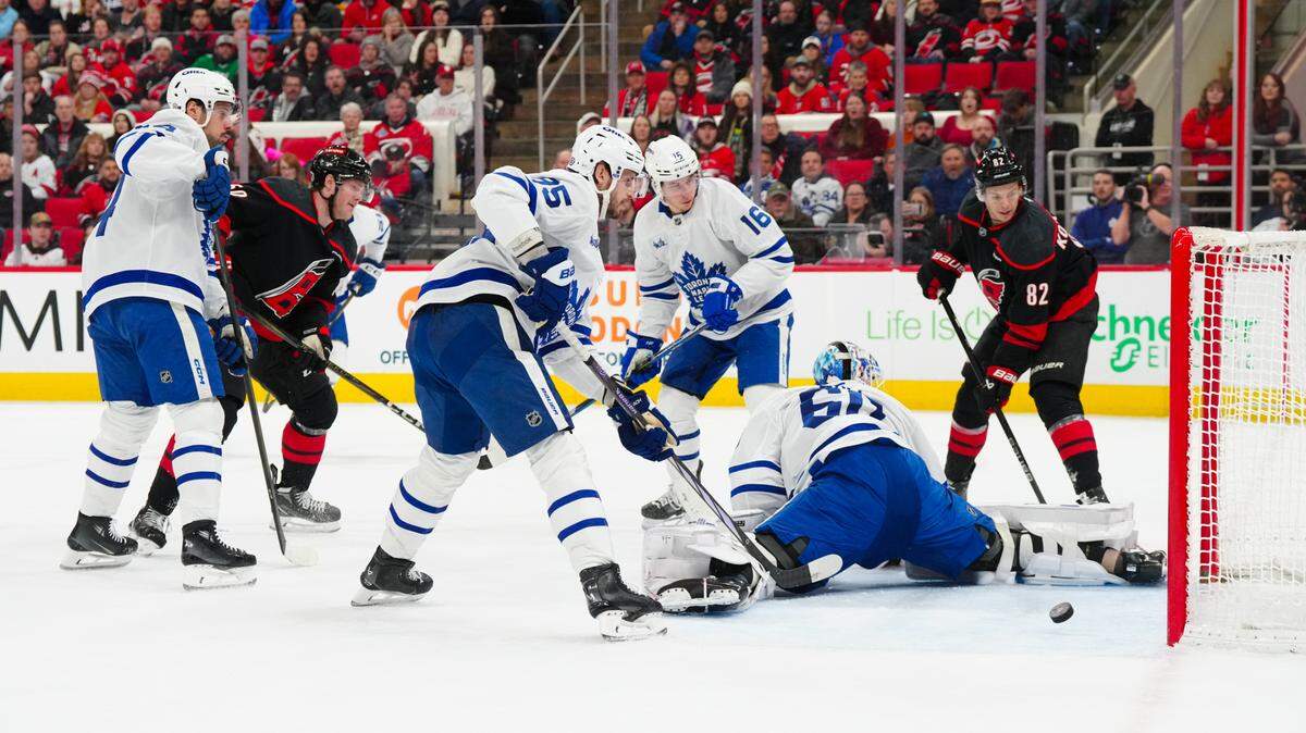 Carolina Hurricanes left wing Eric Robinson (50) scores a goal past Toronto Maple Leafs goaltender Joseph Woll (60) during the first period at Lenovo Center.