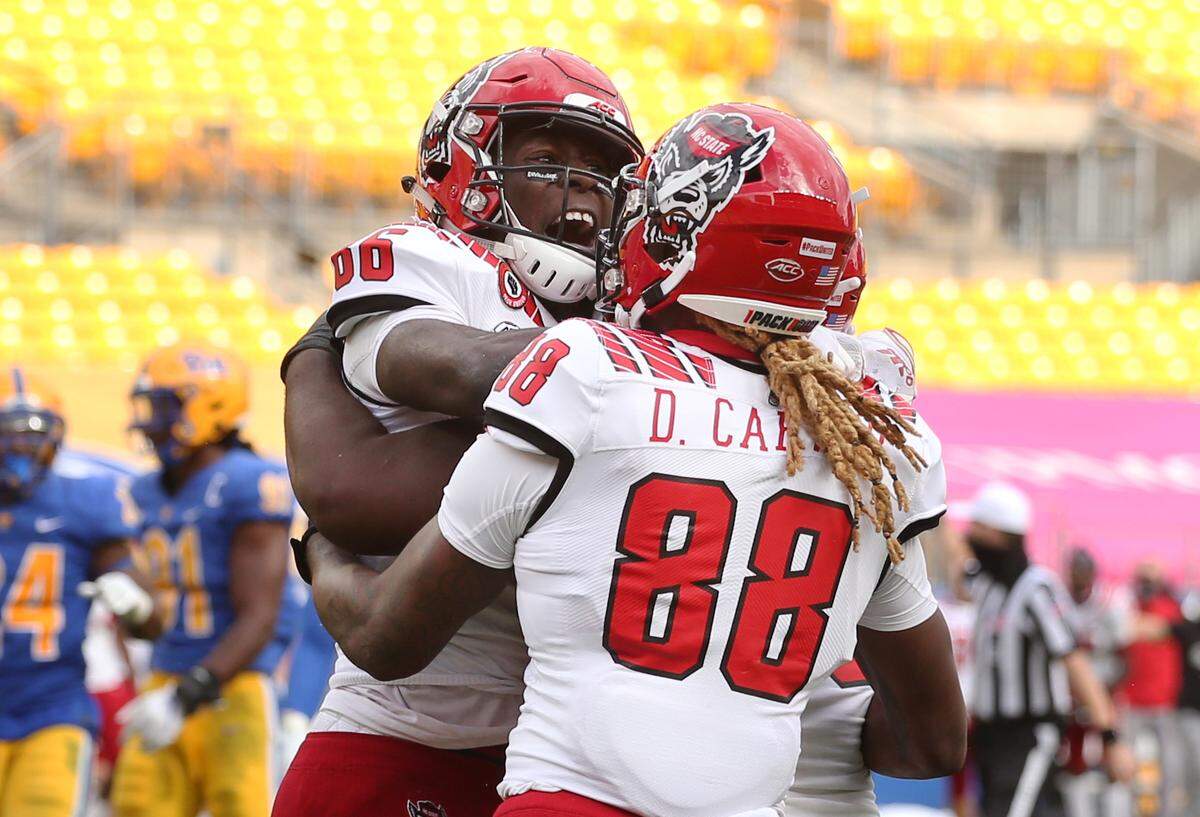N.C. State Wolfpack wide receiver Emeka Emezie (86) celebrates his game winning touchdown with wide receiver Devin Carter (88) against the Pittsburgh Panthers during the fourth quarter at Heinz Field. The Wolfpack won 30-29.