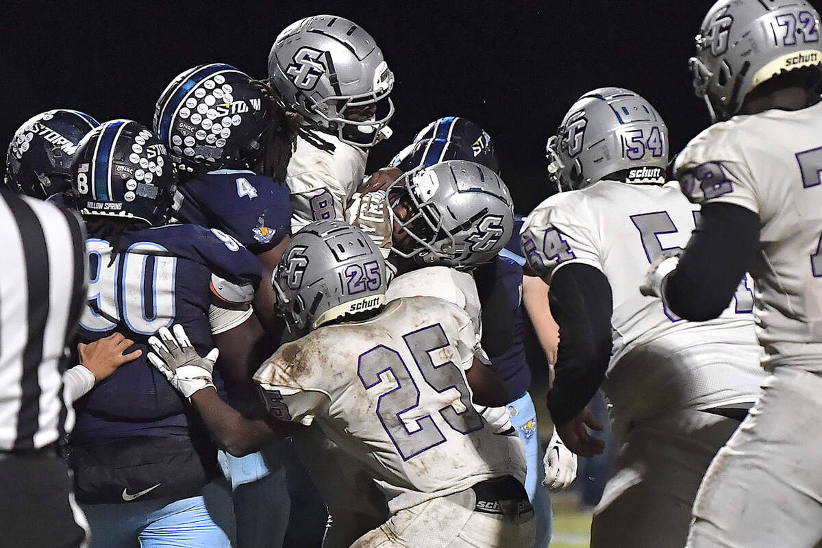 The Willow Spring defensive line stops the rush for the touchdown by South Garner quarterback Chase Hardy (8) late in the fourth quarter. The Willow Spring Storm and the South Garner Titans met in a football game in Fuquay-Varina. N.C. on October 18, 2024.