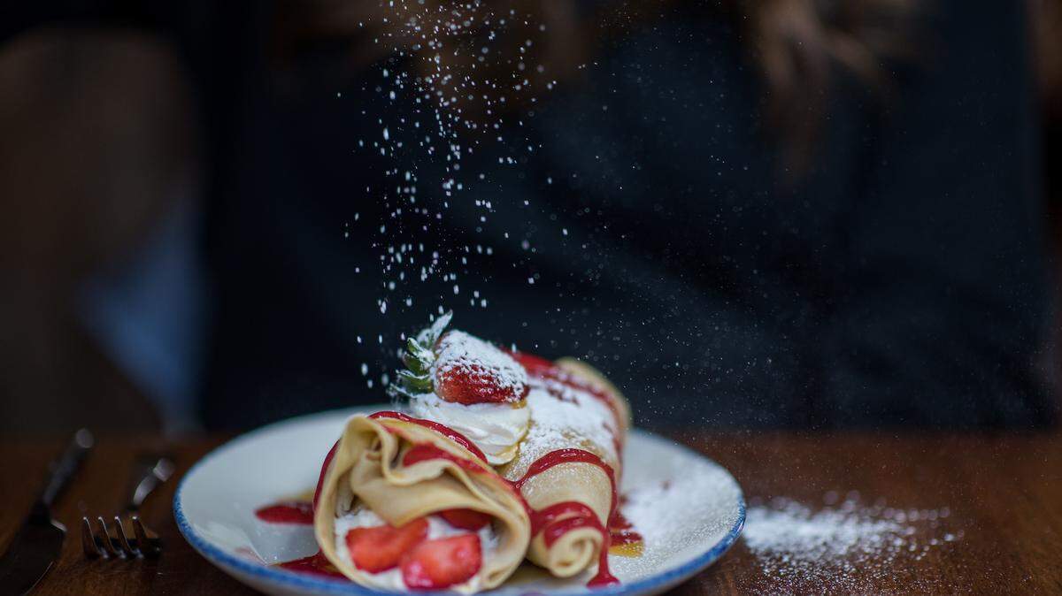 Simply Crepes serves sweet and savory crepes. These are made with fresh strawberries and whipped cream.