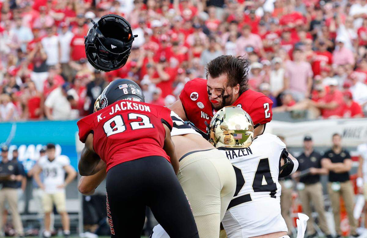 N.C. State quarterback Grayson McCall (2) helmet goes flying after being hit during the first half of N.C. State’s game against Wake Forest at Carter-Finley Stadium in Raleigh, N.C., Saturday, Oct. 5, 2024. McCall was injured on the play.