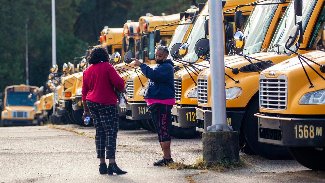 Wake County school bus drivers return to a parking area on Capital Blvd. in Raleigh after completing morning routes Friday, Oct. 29, 2021. Wake County parents and students experienced bus delays Friday morning, and school officials warned of widespread delays as drivers began an expected sickout.