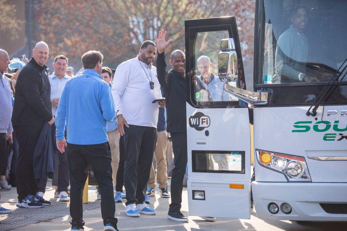 As the UNC basketball team starts their journey to the Final Four in New Orleans, head coach Hubert Davis waves to fans outside the Dean Dome in Chapel Hill, N.C. as Armando Bacot steps onto the bus on Wednesday, March 30, 2022.