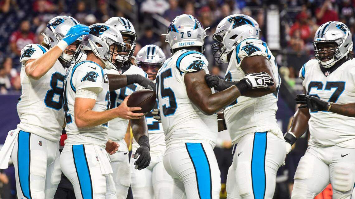 Panthers offensive linemen celebrate after quarterback Sam Darnold, second from left, scores a touchdown against the Texans last season. Carolina allowed the fifth-most sacks in the NFL last season.