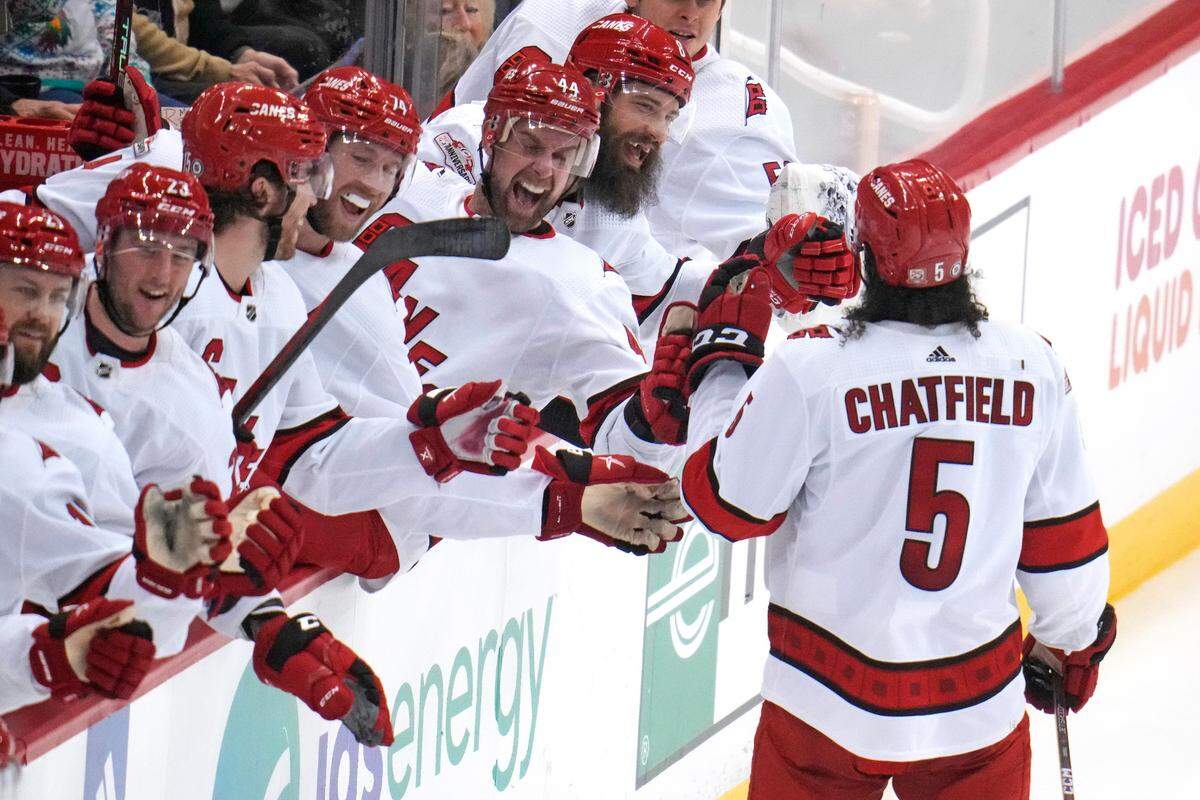 Carolina Hurricanes’ Jalen Chatfield (5) returns to the bench after scoring during the first period of an NHL hockey game against the Pittsburgh Penguins in Pittsburgh, Thursday, Dec. 22, 2022. (AP Photo/Gene J. Puskar)