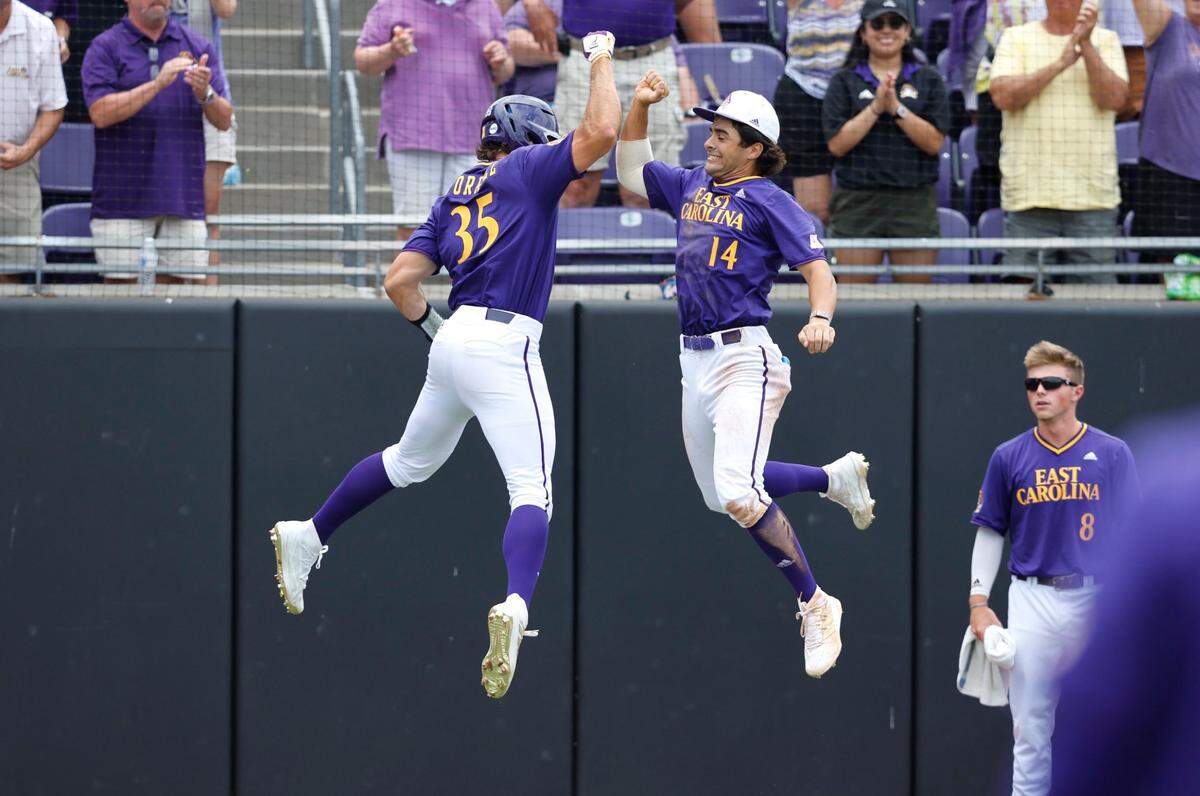 East Carolina’s Bryson Worrell (35) celebrates with Zach Agnos (14) after Worrell hit a homerun in fourth inning during ECUs game against Texas in the NCAA Greenville Super Regional at Clark-LeClair Stadium Saturday, June 11, 2022.