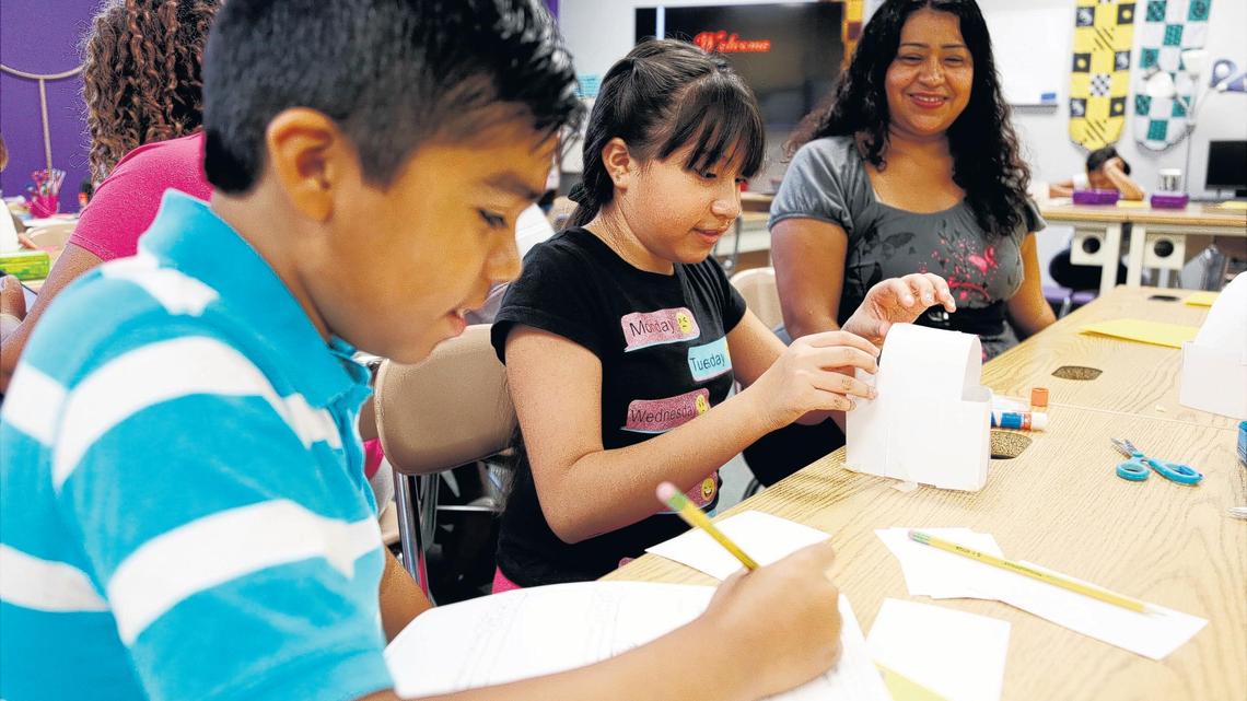 From left, fourth-graders Eugenio Cabrera-Lugo and Kimberly Giramldo work on a team building exercise in Ali Smith’s classroom as Eugenio’s mom, Alma Lugo, center right, looks on at Barwell Road Elementary School on Wednesday, July 25, 2018. The school is holding two half-day orientation sessions for parents and students before the first full day of school Friday.