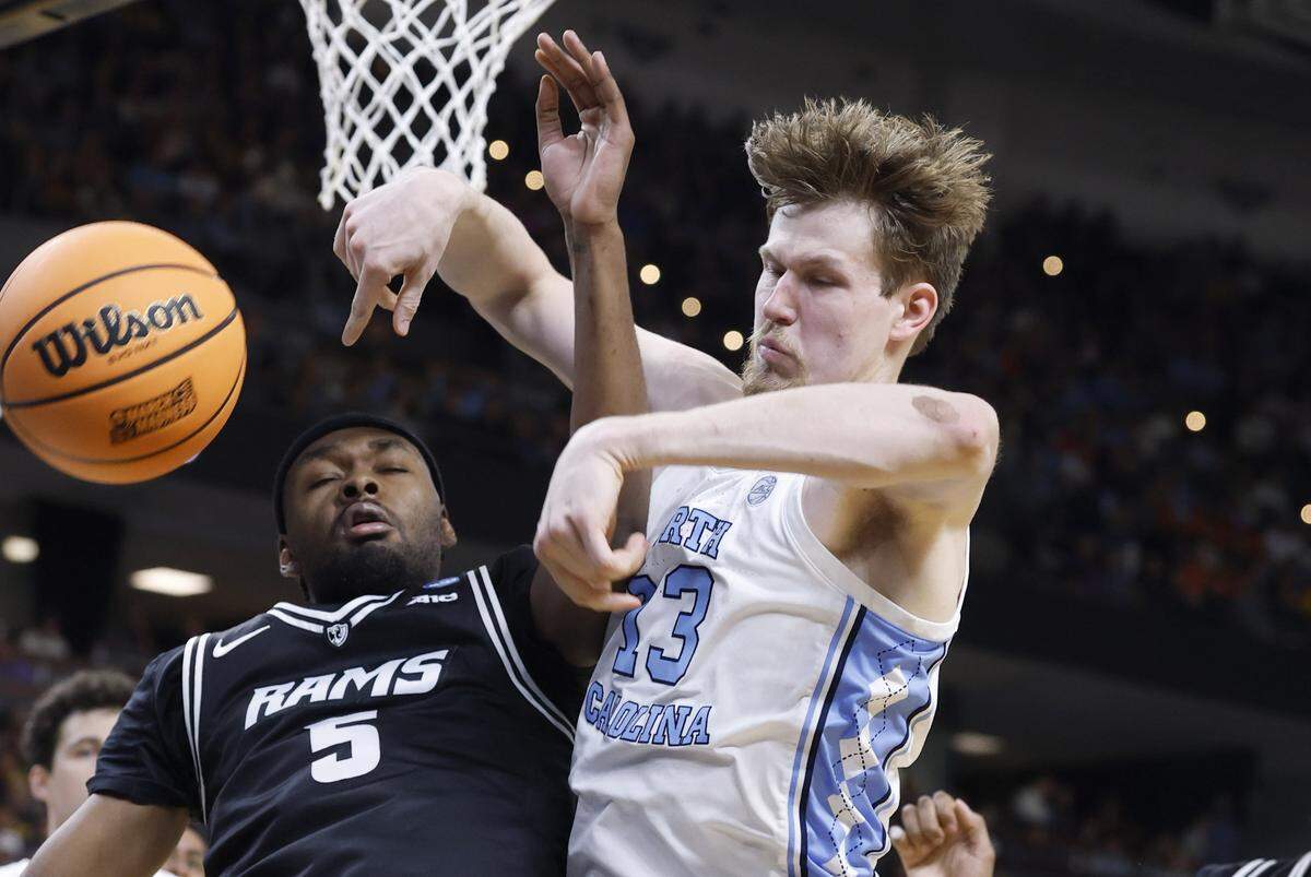 North Carolina's Henri Veesaar (13) fights for the ball with VCU’s Barry Evans (5) during the first half of UNC’s game against VCU in the first round of the NCAA Men’s Basketball Tournament at  Bon Secours Wellness Arena in Greenville, S.C., Thursday, March 19, 2026.