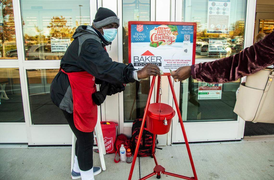 Ernestine McDade, a Salvation Army bell ringer, accepts donations from shoppers at Hobby Lobby on Capital Boulevard in Raleigh Friday, Nov. 20, 2020.