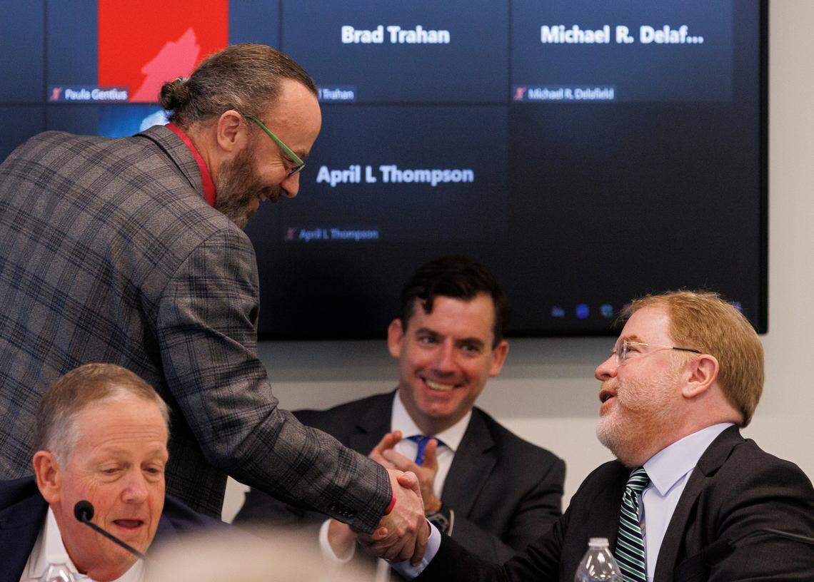 Wade Maki, chair of the UNC Faculty Assembly, shakes hands with UNC System President Peter Hans during a meeting of the UNC System Board of Governors on Thursday, Feb. 29, 2024, in Raleigh, N.C.