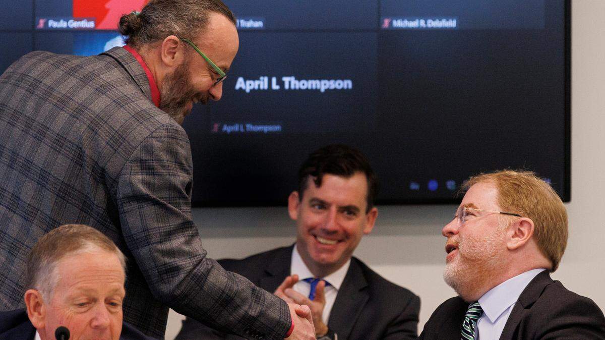Wade Maki, chair of the UNC Faculty Assembly, shakes hands with UNC System President Peter Hans during a meeting of the UNC System Board of Governors on Thursday, Feb. 29, 2024, in Raleigh, N.C.