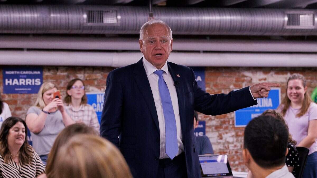Democratic vice presidential nominee and Minnesota Gov. Tim Walz speaks with volunteers at a campaign office during a visit to Raleigh, N.C. on Thursday, Aug. 29, 2024.