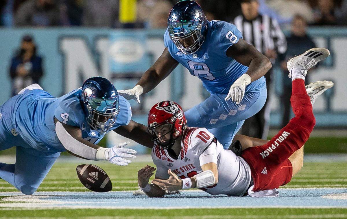 N.C. State quarterback Ben Finley fumbles the ball in the third quarter against North Carolina on Friday, November 25, 2022 at Kenan Stadium in Chapel Hill, N.C.