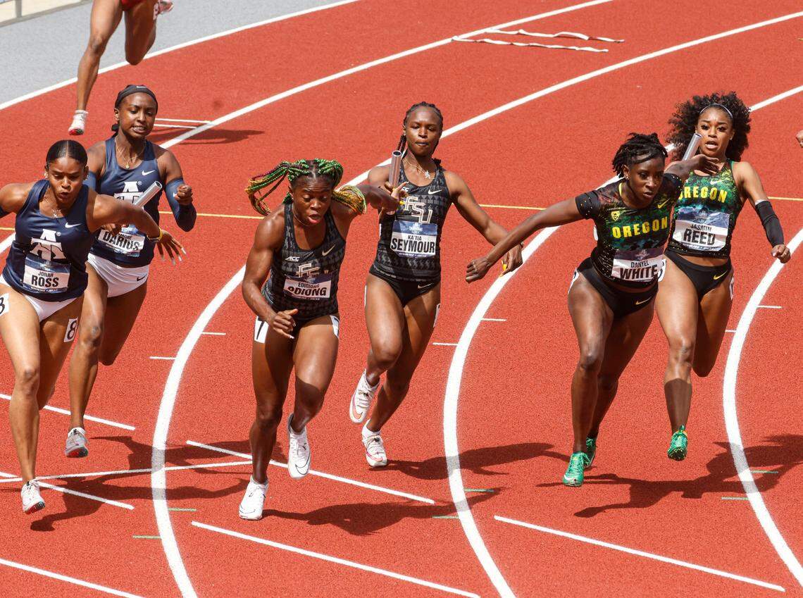 Runners compete in a women’s 4x100 semifinal during the NCAA Division I Outdoor Track and Field Championships, Thursday, June 10, 2021, at Hayward Field in Eugene, Ore. From left are North Carolina A&T’s Jonah Ross and Symone Darius; Florida State’s Edidiong Odiong and Ka’Tia Seymour; and Oregon’s Danyel White and Jasmin Reed. (AP Photo/Thomas Boyd)