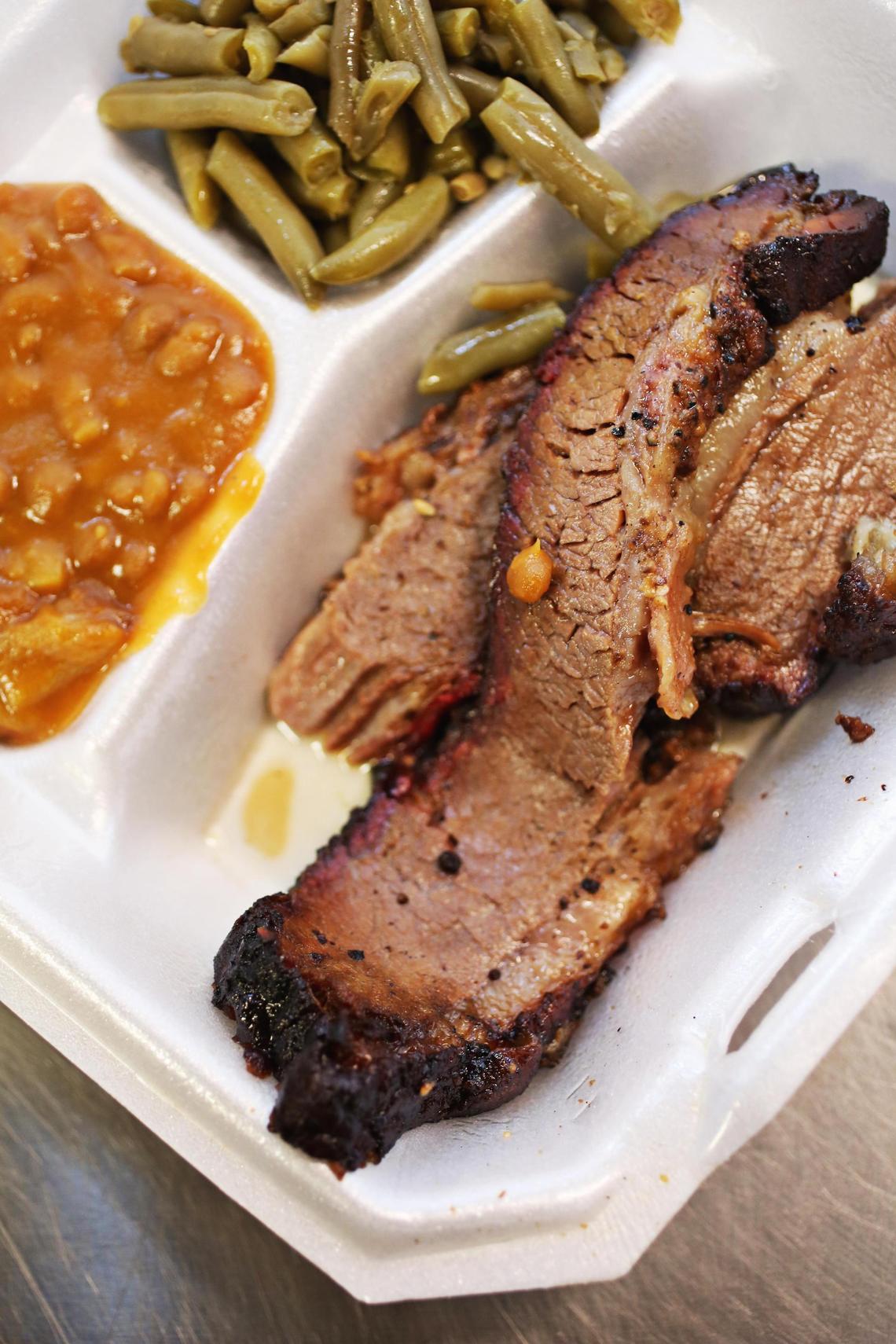 Rob Henson’s Blue Cheese Brisket is smoked low and slow for eight hours, before he coats it with blue cheese crumbles and smokes it for four more. Here it is served with ham hock green beans and ÒdoctoredÓ baked beans.