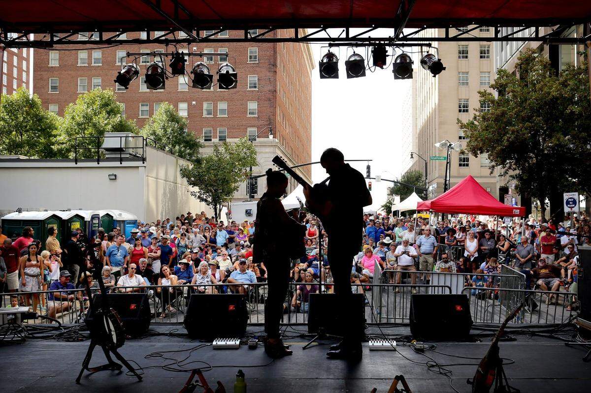 The Honey Dewdrops band members Laura Wortman, left, and Kagey Parrish perform in downtown Raleigh during the IBMA Bluegrass Festival in 2016.