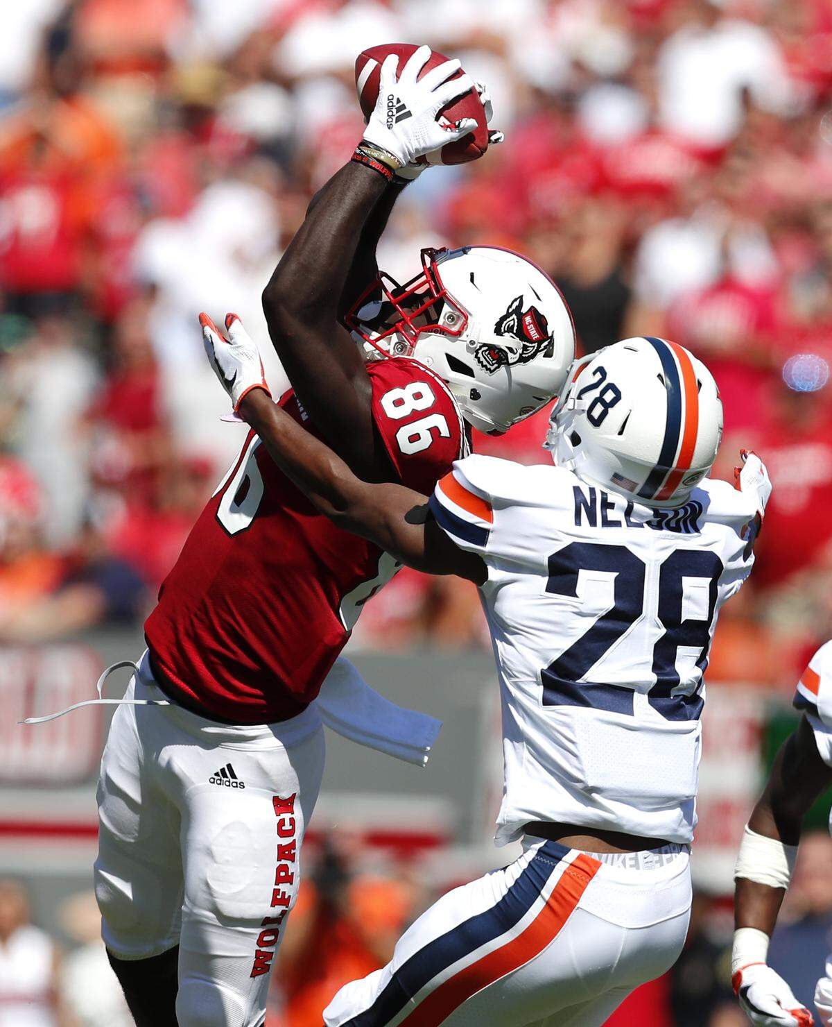 N.C. State wide receiver Emeka Emezie (86) pulls in a reception as Virginia safety Brenton Nelson (28) defends during the first half of N.C. State’s game against Virginia at Carter-Finley Stadium in Raleigh, N.C., Saturday, Sept. 29, 2018.