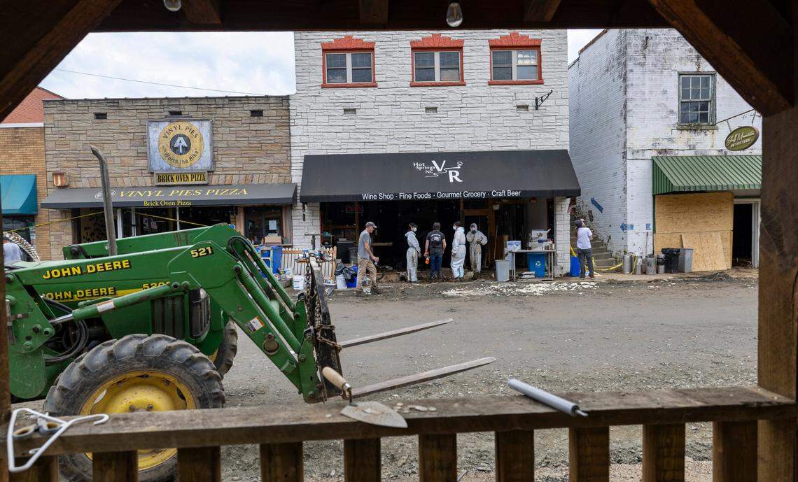 Business owners with an army of volunteers work to clean mud from flooded business on Bridge Street on Friday, October 4, 2024, after flooding from Hurricane Helene destroyed many of them.