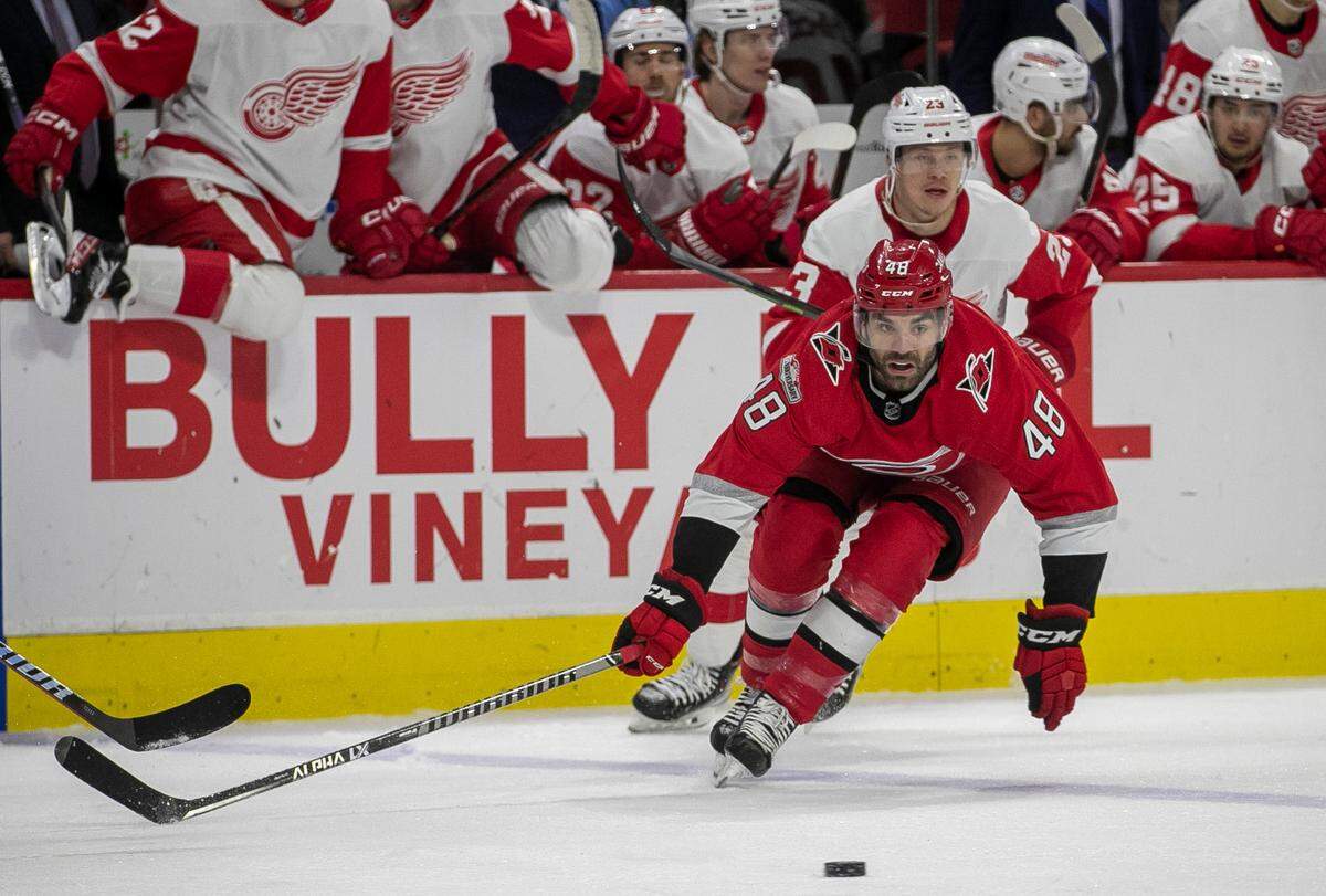 Carolina Hurricanes’ Jordan Martinook (48) goes after the puck ahead of Detroit’s Lucas Raymond (23) in the first period on Tuesday, April 11, 2023 at PNC Arena in Raleigh, N.C.