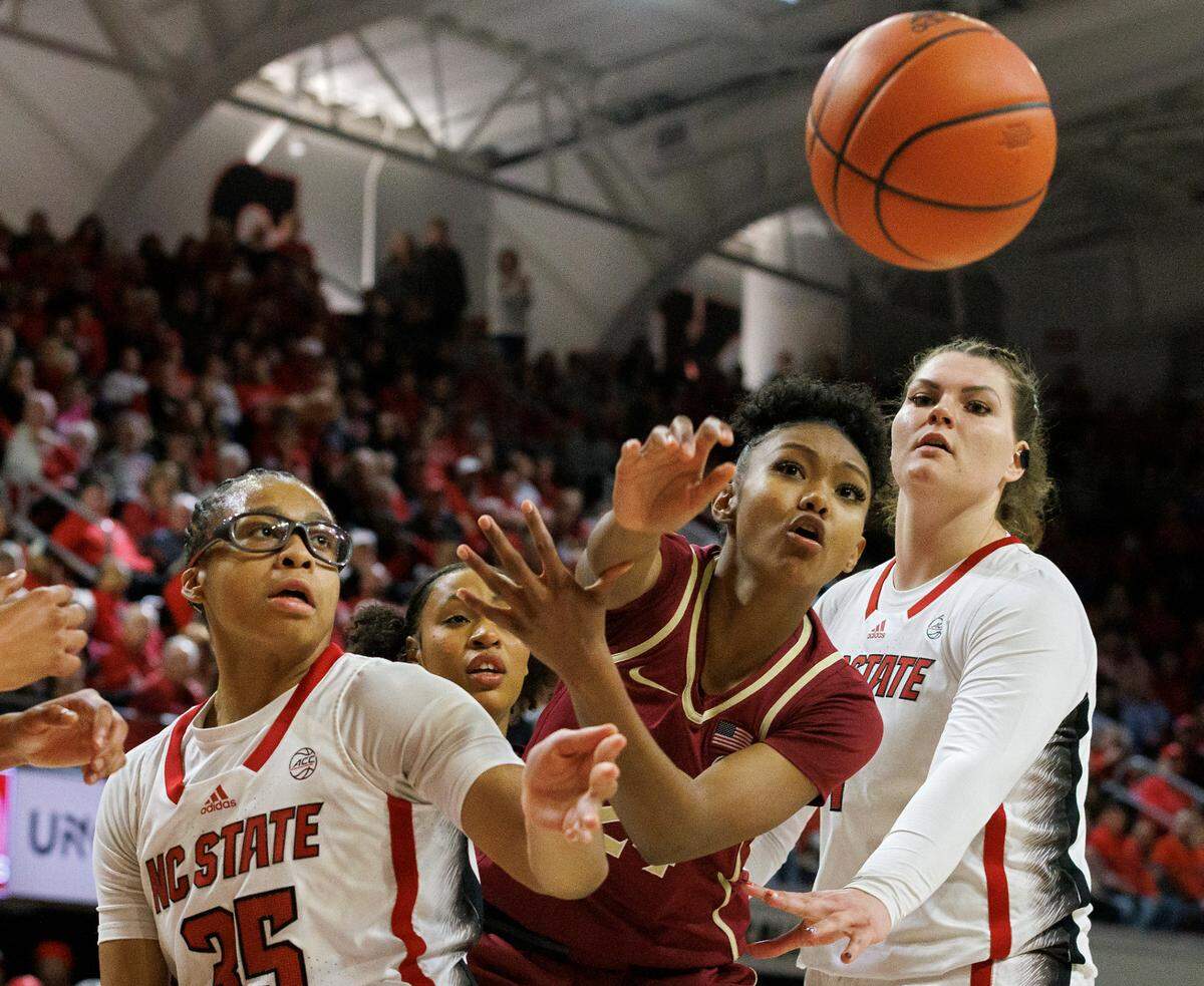N.C. State’s Zoe Brooks and Florida State Seminoles guard Amaya Bonner vie for a loose ball during the second half of the Wolfpack’s 88-80 win on Thursday, Jan. 4, 2023, at Reynolds Coliseum in Raleigh, N.C.