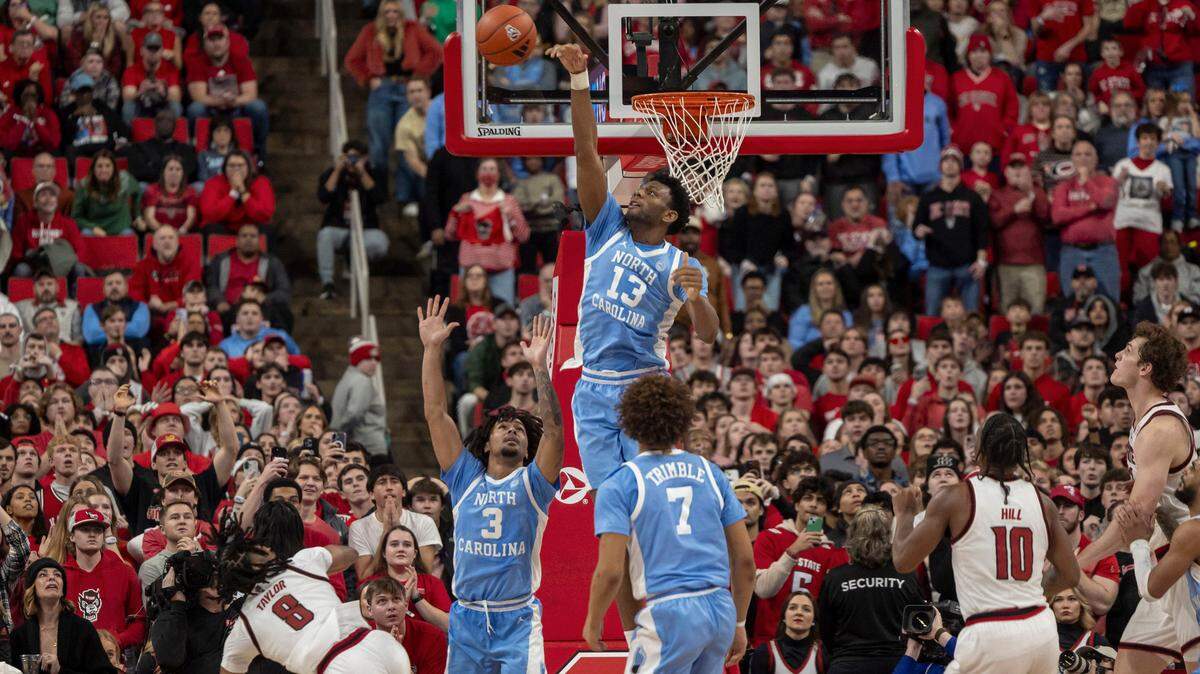 North Carolina forward Jalen Washington (13) blocks a two-point shot attempt to tie the game by N.C. State’s Jayden Taylor (8) with one second to play, securing the Tar Heels’ 63-61 victory on Saturday, January 11, 2025 at Lenovo Center in Raleigh, N.C.