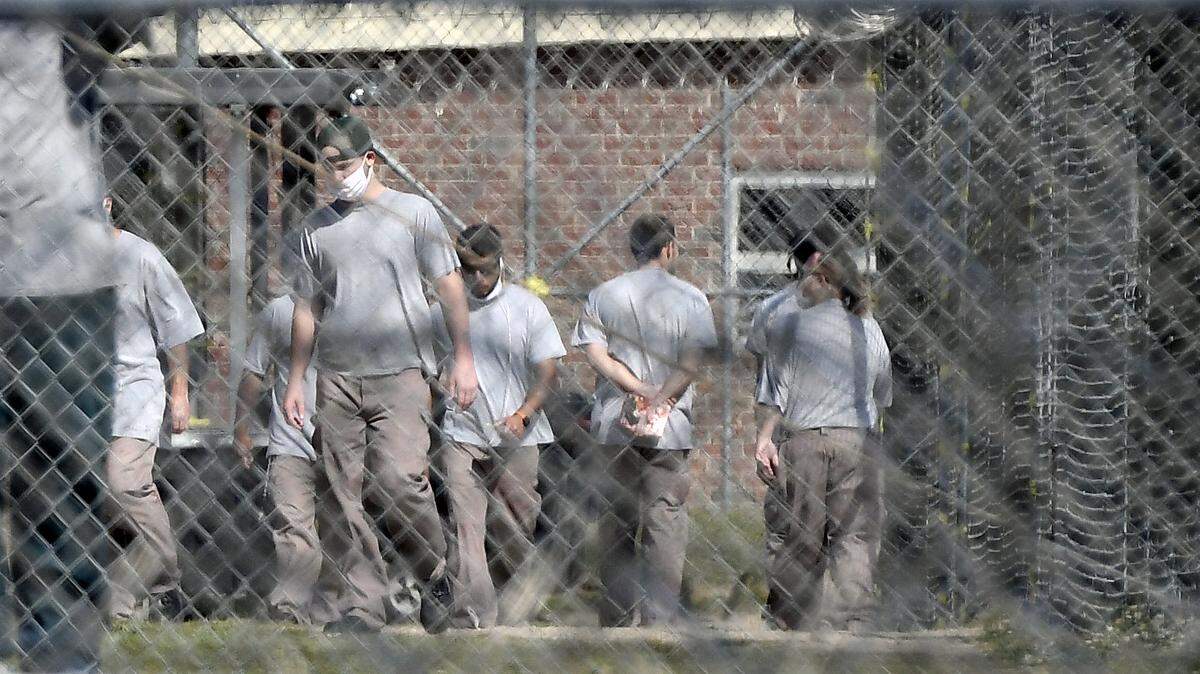 Inmates at the Neuse Correctional Institution in Goldsboro, N.C. move between buildings Sunday morning, April 19, 2020.