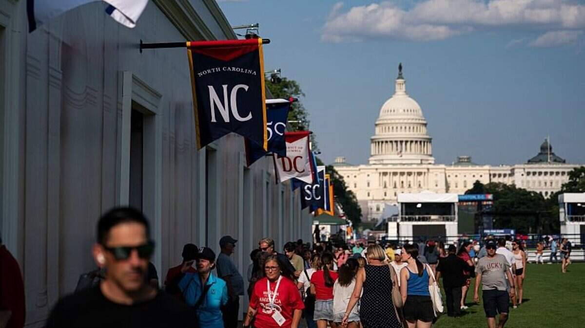 WASHINGTON, DC - JUNE 25: Visitors walk past the West Virginia and North Carolina exhibits on the first day of the "Great American State Fair" on the National Mall on June 25, 2026 in Washington, DC. The Freedom 250-backed Great American State Fair celebrating the 250th anniversary of the United States runs through July 10th. (Photo by Al Drago/Getty Images)