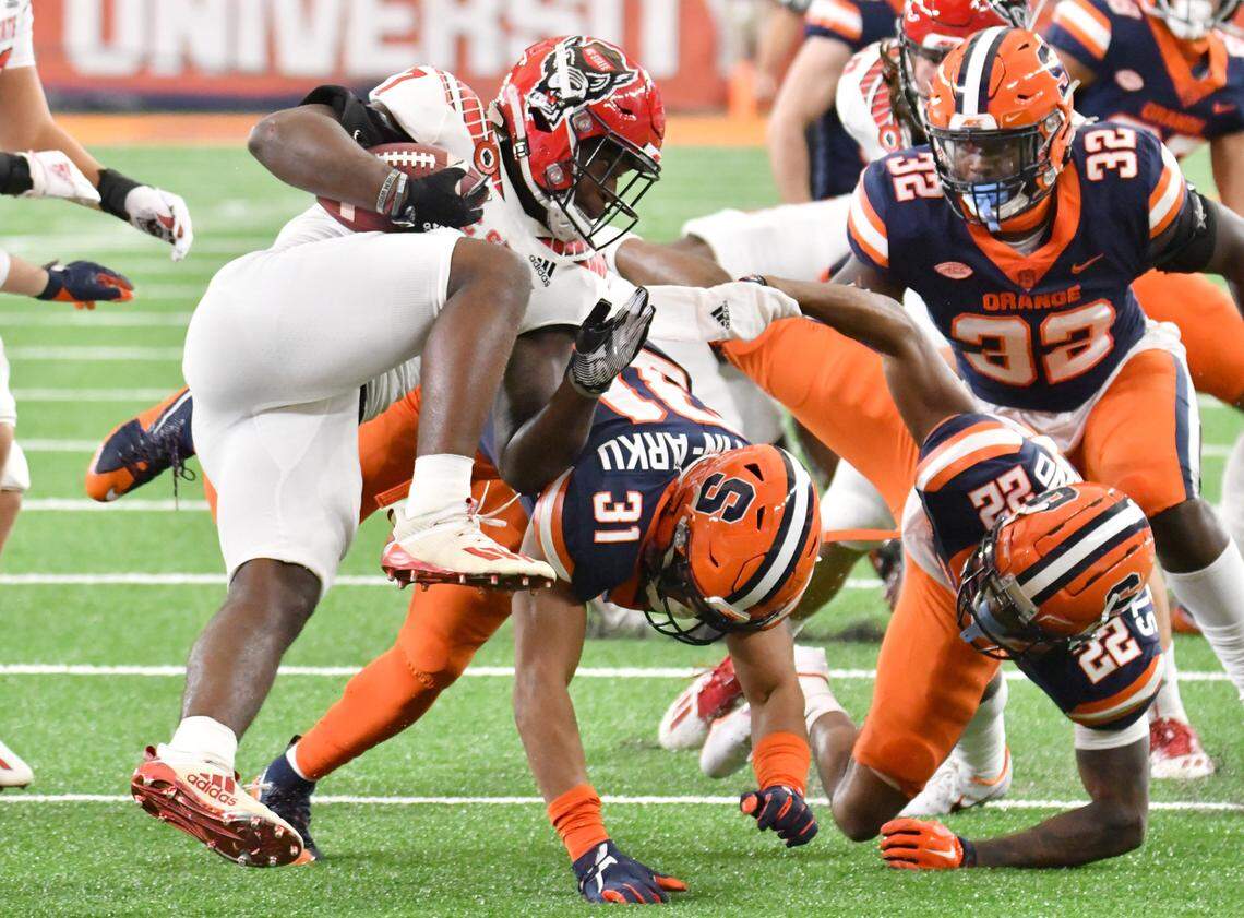 Nov 28, 2020; Syracuse, New York, USA; North Carolina State Wolfpack running back Zonovan Knight (7) is tackled by Syracuse Orange linebacker Geoff Cantin-Arku (31) on a kickoff return in the second quarter at the Carrier Dome.