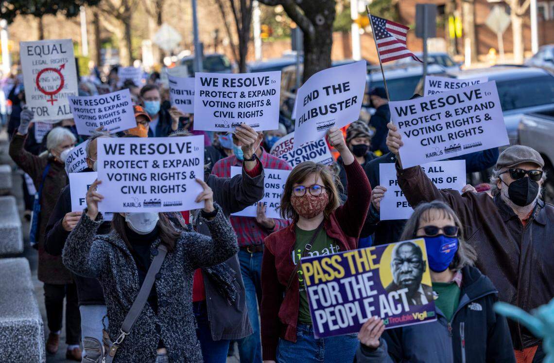 About 150 people demonstrate outside the Federal Building on New Bern Avenue in Raleigh Thursday, Jan.6 2022 on the one year anniversary of the U.S. Capitol attack. The protest organized by the North Carolina Poor People’s Campaign urged lawmakers to pass the Freedom to Vote Act and the Protecting Our Democracy Act.