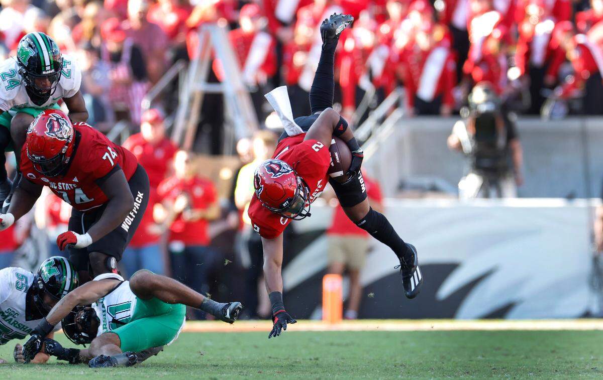 N.C. State running back Michael Allen (2) goes flying after being hit during a run in the second half of N.C. State’s 48-41 victory over Marshall at Carter-Finley Stadium in Raleigh, N.C., Saturday, Oct. 7, 2023.