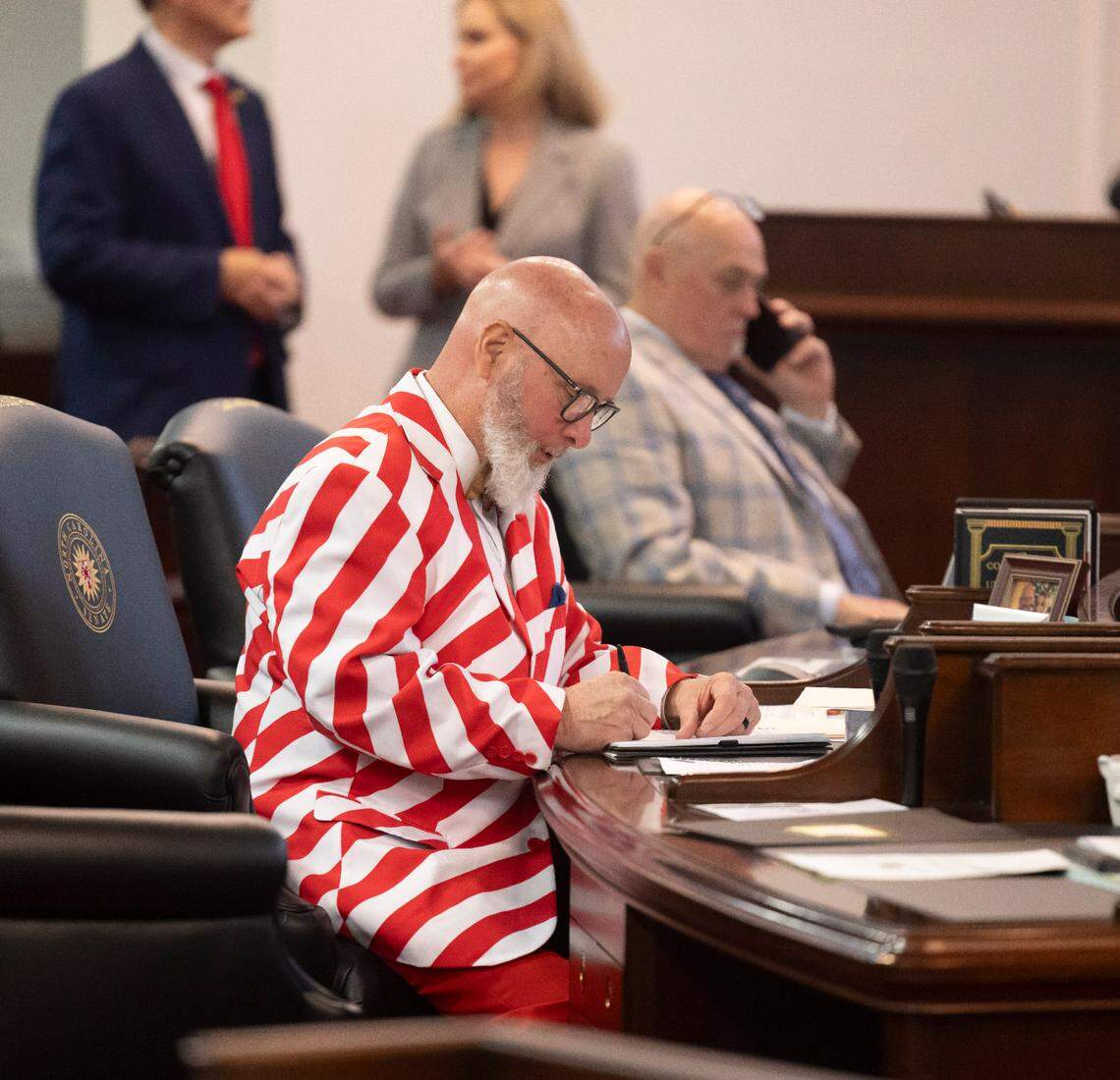 Senator Bobby Hanig works at his desk in the Senate chamber prior to offering an amendment to the Senate Budget calling for the State to continue to offering free ferry service on Wednesday, April 16, 2025 at the General Assembly in Raleigh, N.C. His amendment was tabled.