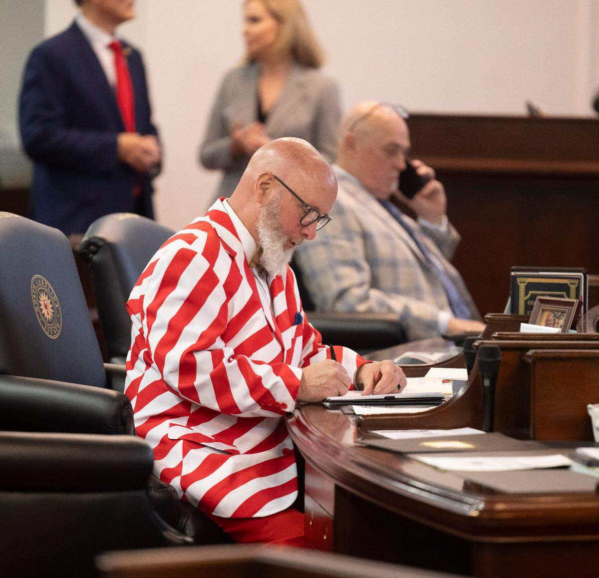 Senator Bobby Hanig works at his desk in the Senate chamber prior to offering an amendment to the Senate Budget calling for the State to continue to offering free ferry service on Wednesday, April 16, 2025 at the General Assembly in Raleigh, N.C.  His amendment was tabled. 