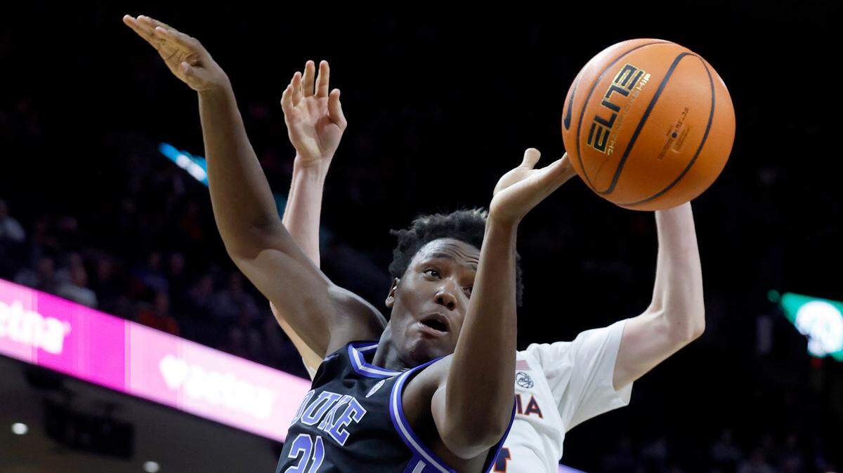 Duke’s Patrick Ngongba II (21) tries to pull in a rebound during the second half of Duke’s 80-62 victory over Virginia at John Paul Jones Arena in Charlottesville, Va., Monday, Feb. 17, 2025.