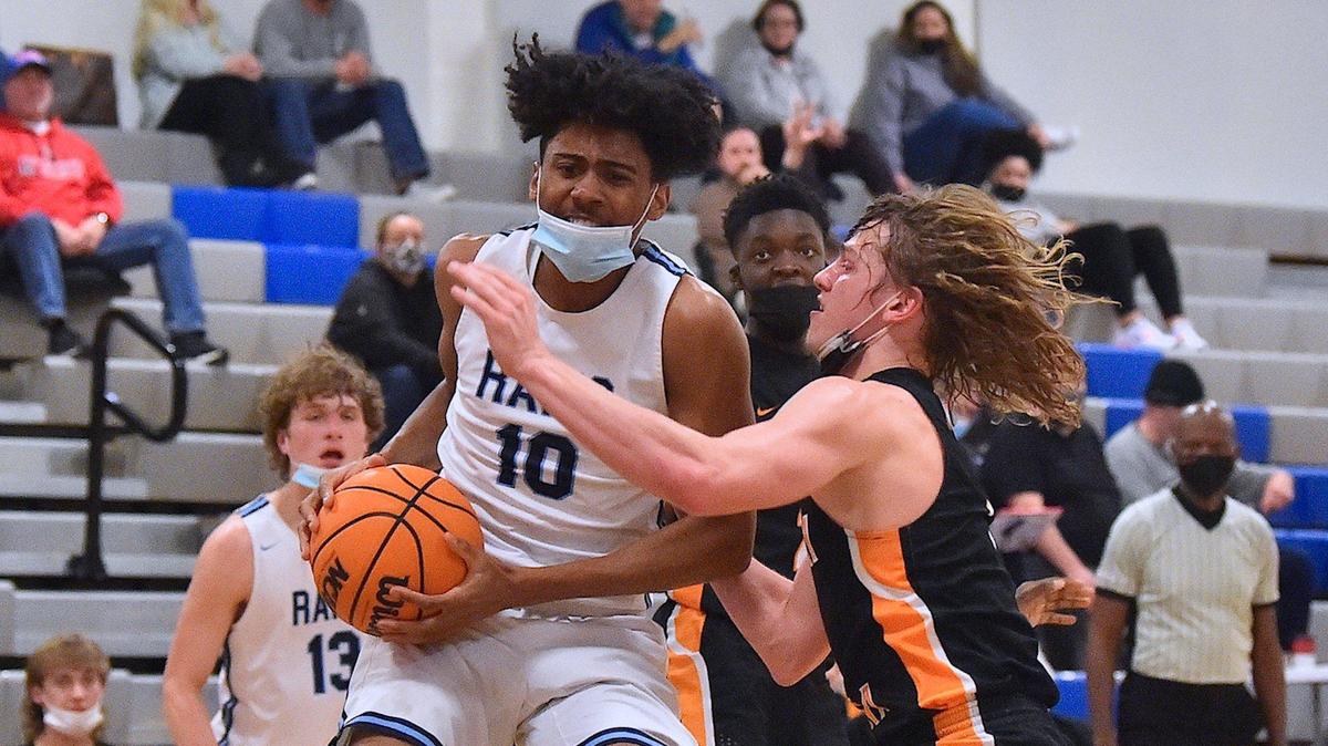 Cleveland’s Trey Fields (10) secures the rebound against Fuquay-Varina’s Jake Hart (1) during the first half. The Cleveland Rams and the Fuquay-Varina Bengals met in the Greater Neuse Conference Championships in Garner, N.C. on February 18, 2022.