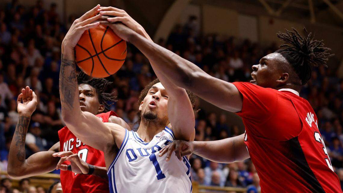 Duke’s Dereck Lively II pulls down a rebound away from North Carolina State’s Terquavion Smith and D.J. Burns Jr. during the first half of Duke’s final regular-season home game against N.C. State on Tuesday, Feb. 28, 2023, at Cameron Indoor Stadium in Durham, N.C.