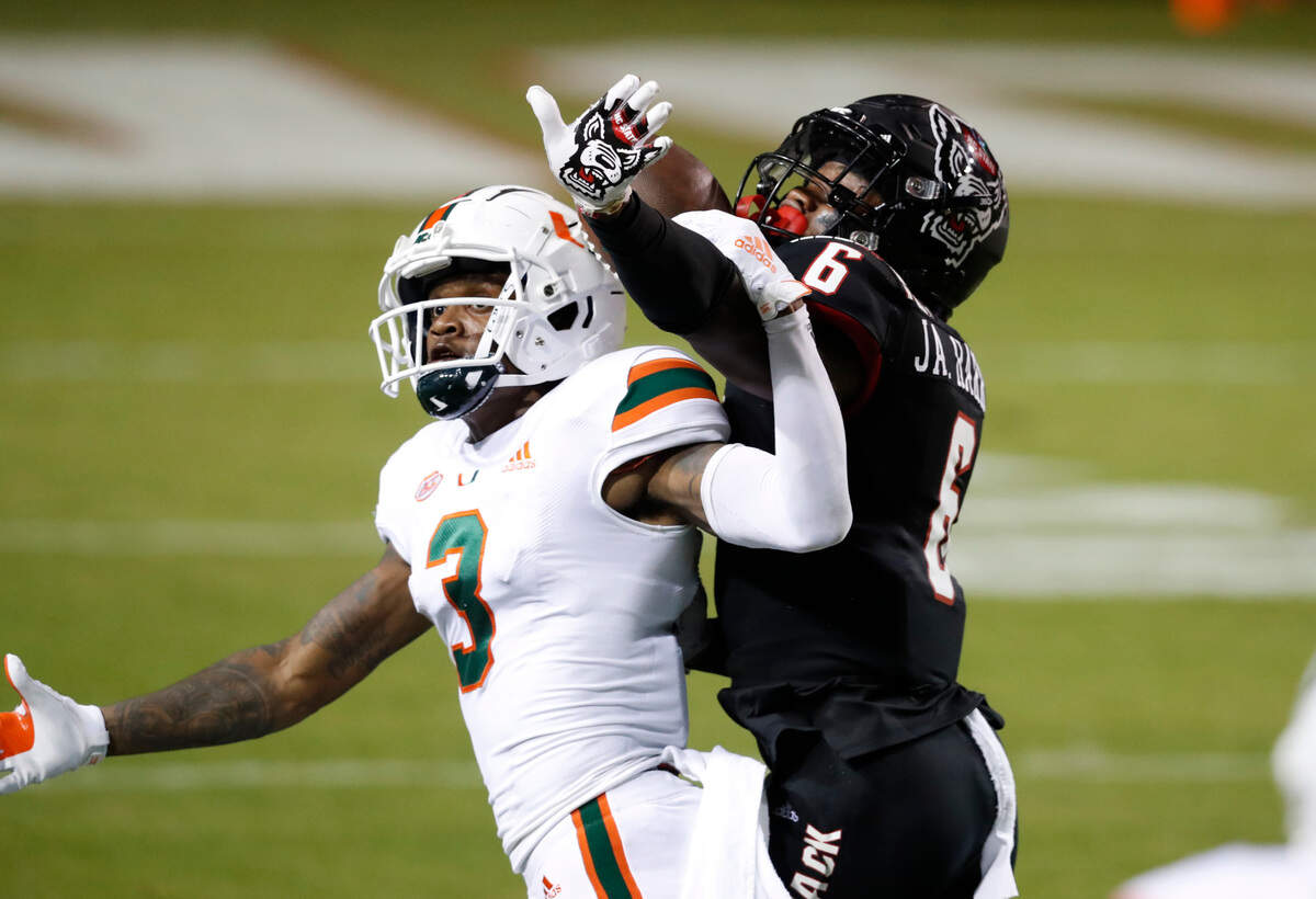 N.C. State safety Jakeen Harris (6) is called for pass interference as he defends Miami wide receiver Mike Harley (3) during the first half of N.C. State’s game against Miami at Carter-Finley Stadium in Raleigh, N.C., Friday, Nov. 6, 2020.