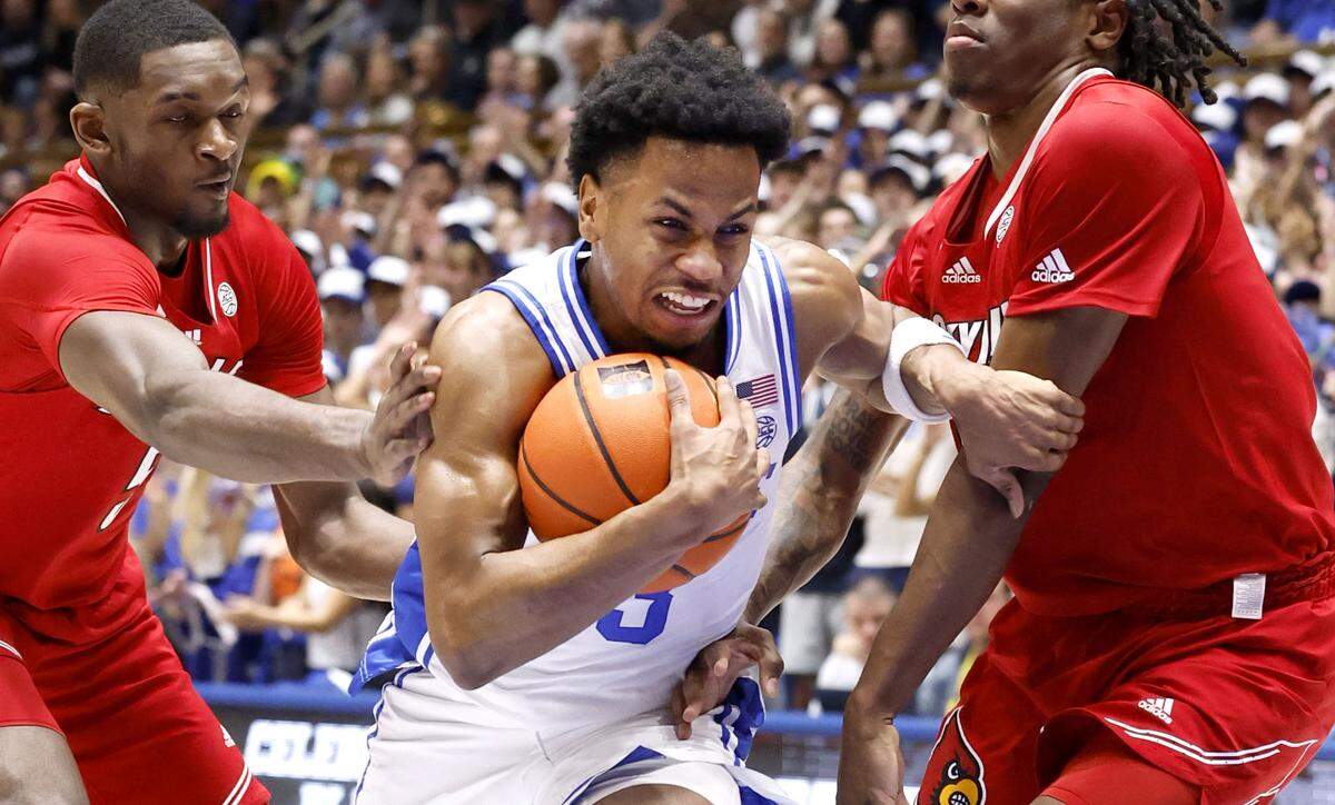Duke’s Jeremy Roach (3) drives by Louisville’s Brandon Huntley-Hatfield (5) and Mike James (0) during the first half of Duke’s game against Louisville at Cameron Indoor Stadium in Durham, N.C., Wednesday, Feb. 28, 2024.