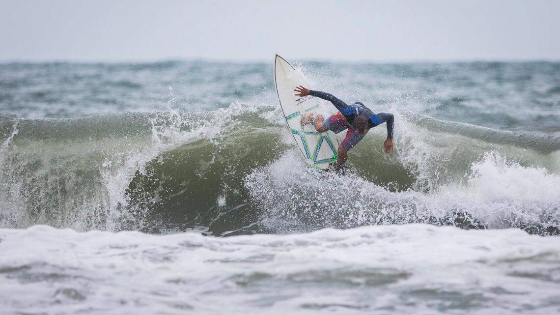 A surfer rides a wave in big swells brought on by Tropical Storm Isaias near Bogue Inlet Pier in Emerald Isle, N.C. on Monday evening, Aug. 3, 2020.
