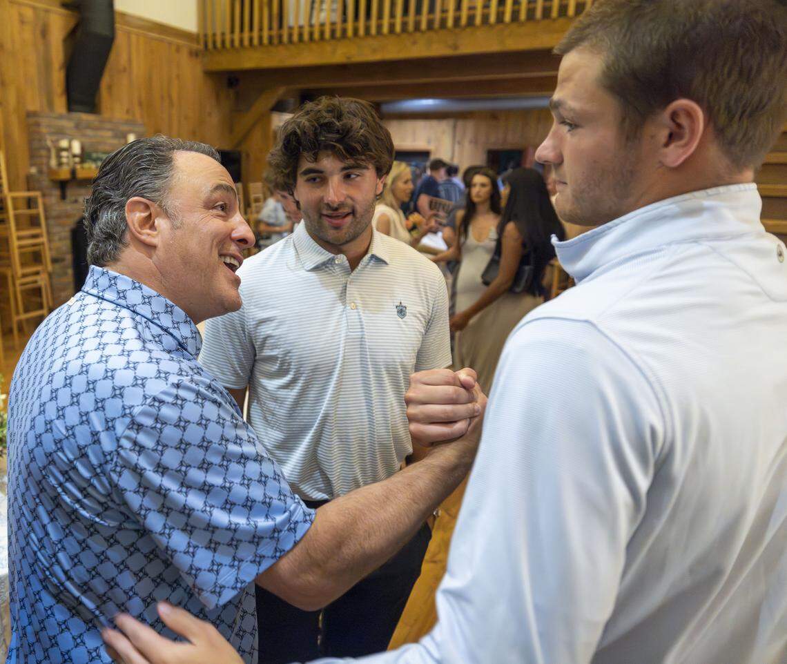 Vaughn Moore shakes hands with New England Patriots quarterback Drake Maye, after rising over $1 million for Table, a non-profit that addresses food insecurities of children and families in Orange County, on Friday, April 17, 2026 in Carrboro, N.C.