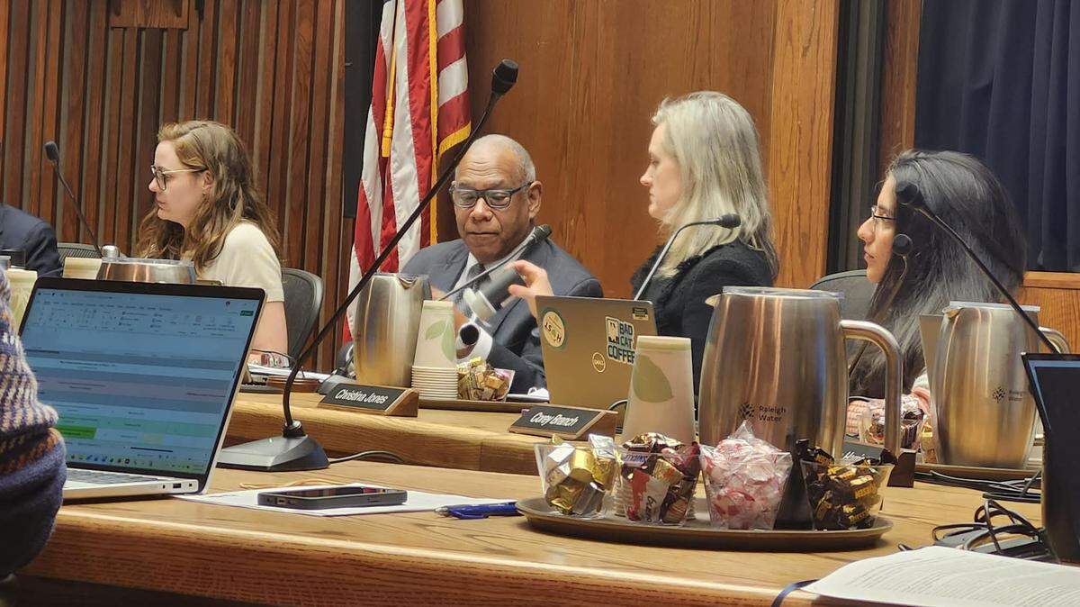 Raleigh Mayor Janet Cowell takes a StarChase Guardian 54 mm GPS round from Council member Mitchell Silver.
