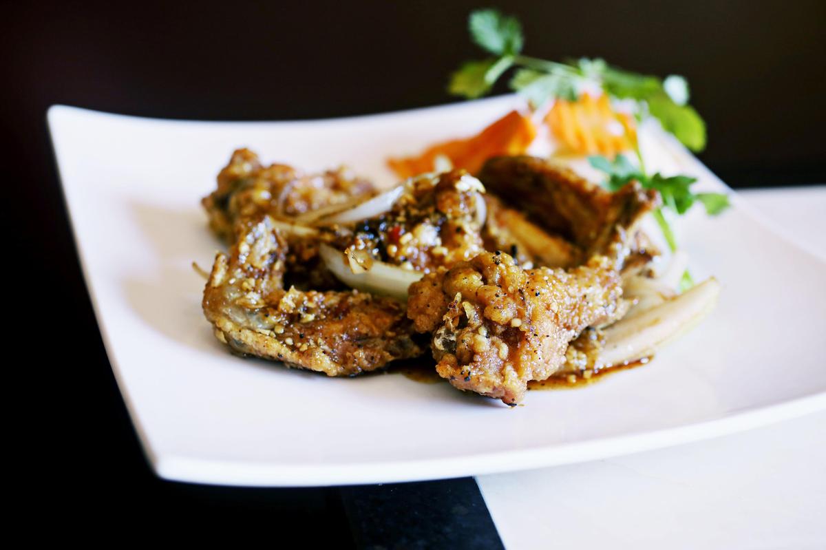 The fish sauce wings are pan-fried and tossed in a garlicky, tangy-sweet glaze at Pho Happiness in Chapel Hill.