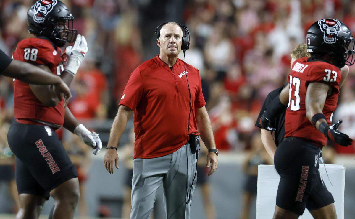 N.C. State head coach Dave Doeren looks at the screen during a timeout in the first half of N.C. State’s game against Virginia Tech at Carter-Finley Stadium in Raleigh, N.C., Saturday, Sept. 27, 2025.