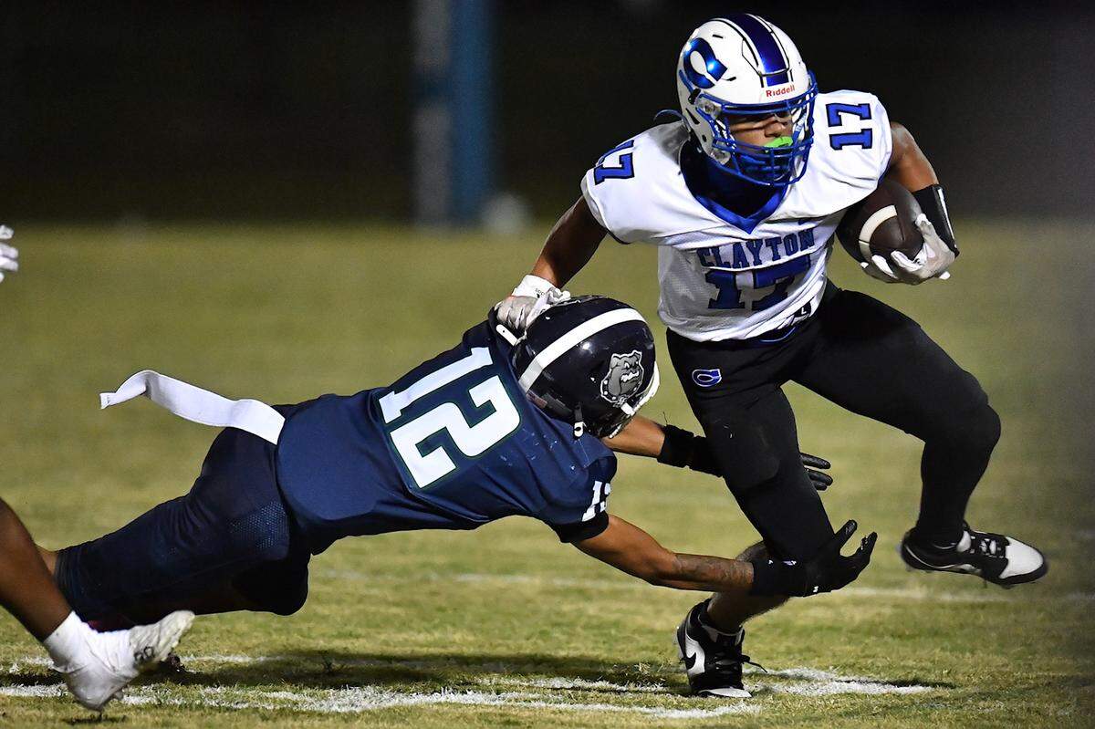 Clayton wide receiver Parker Ferguson (17) runs towards the sidelines against Southeast Raleigh defensive back Ziyir Stanley (12) during the first half. The Southeast Raleigh Bulldogs and the Clayton Comets met in a non-conference football game in Raleigh, N.C. October 3, 2025
