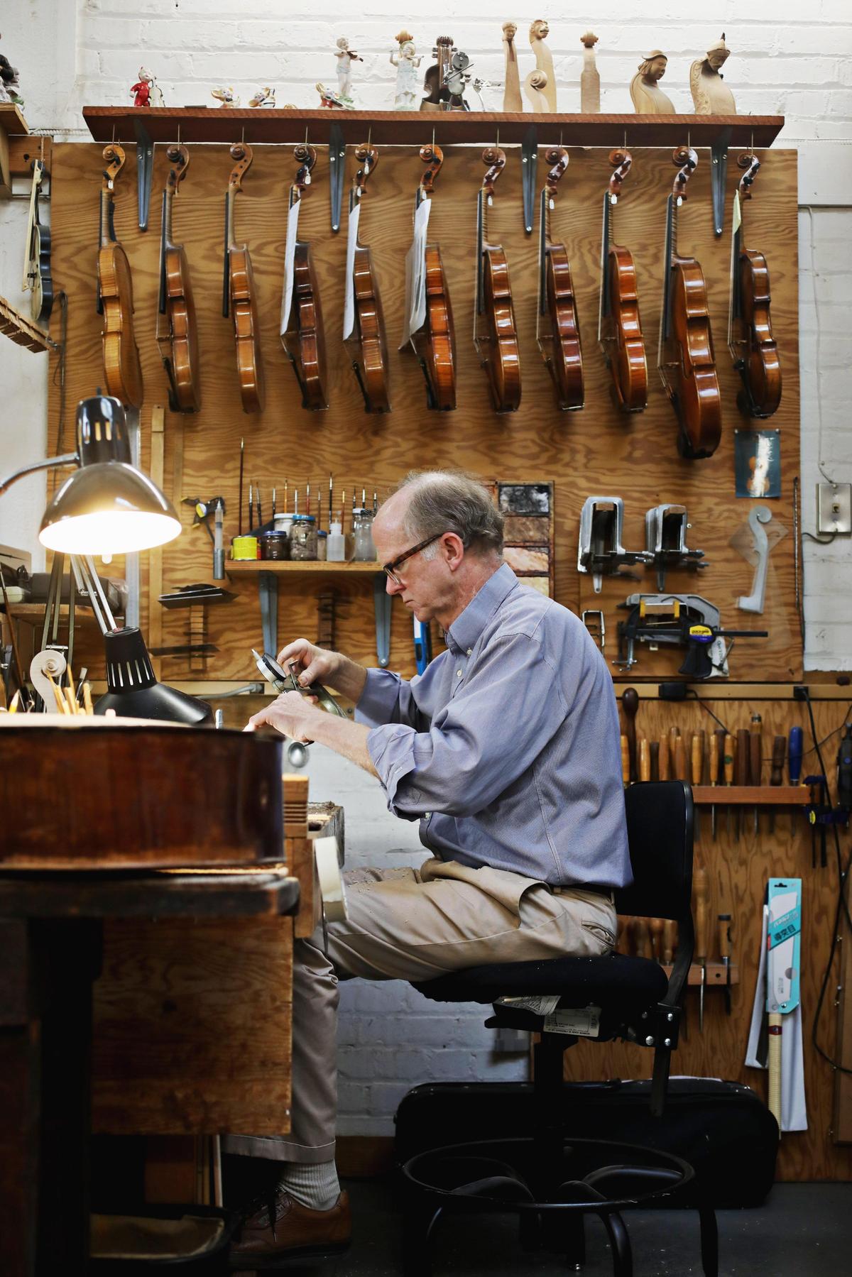 Violin maker John Montgomery works on a violin in his shop on Raleigh’s Hillsborough Street, March 27, 2019. Montgomery, who graduated from the Violin Making School of America in Utah, opened his shop in 1987.
