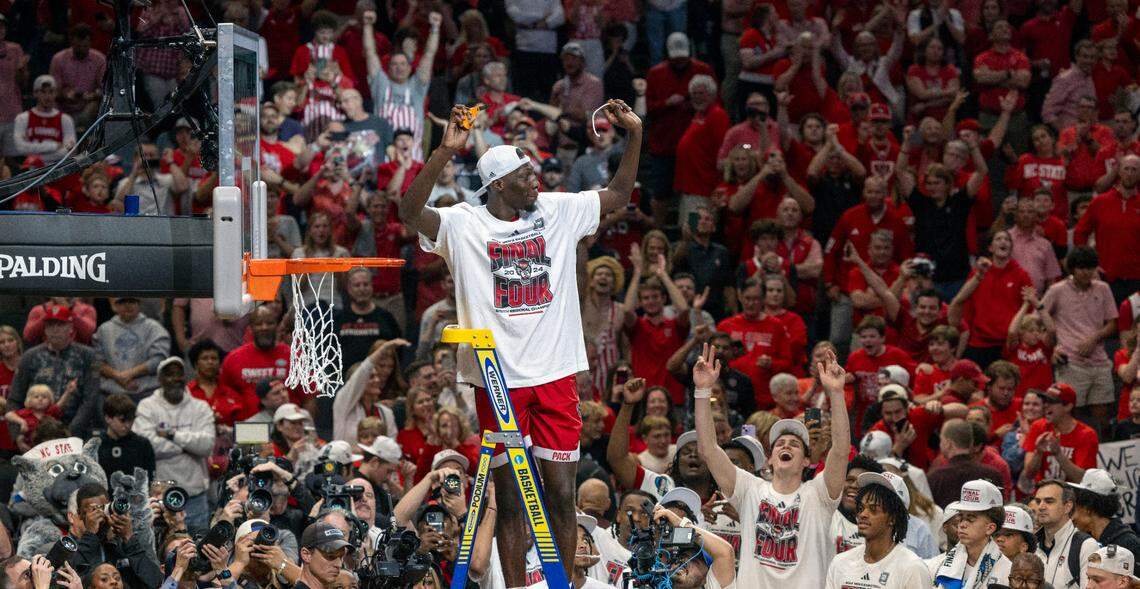 Mohamed Diarra (23) acknowledges fans as he cuts down the net following the Wolfpack’s 76-64 victory over Duke, clinching the NCAA South Regional final and securing a spot in the Final Four on Sunday, March 31, 2024 at the American Airlines Center in Dallas, Texas.