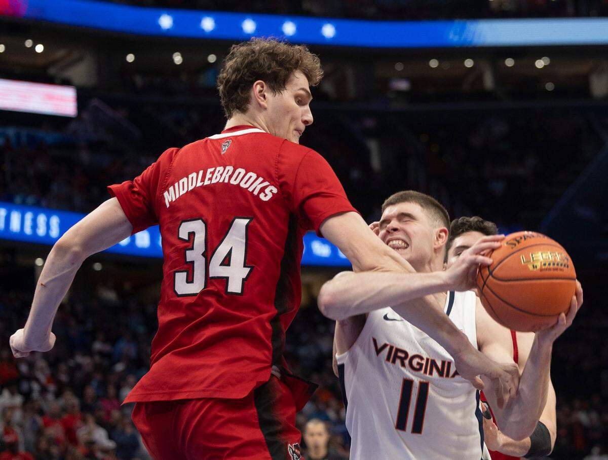 N.C. State’s Ben Middlebrooks (34) defends Virginia’s Isaac McKneely (11) in the second half during the semi-finals of the ACC Men’s Basketball Tournament at Capitol One Arena on Friday, March 15, 2024 in Washington, D.C.