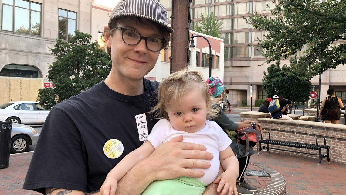 Dante Strobino, 38, Durham, with daughter Leota. “We’re out here because white silence is violence”